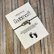 Godfather bracelet with customized initial charm, placed on "Will you be my godfather" proposal card